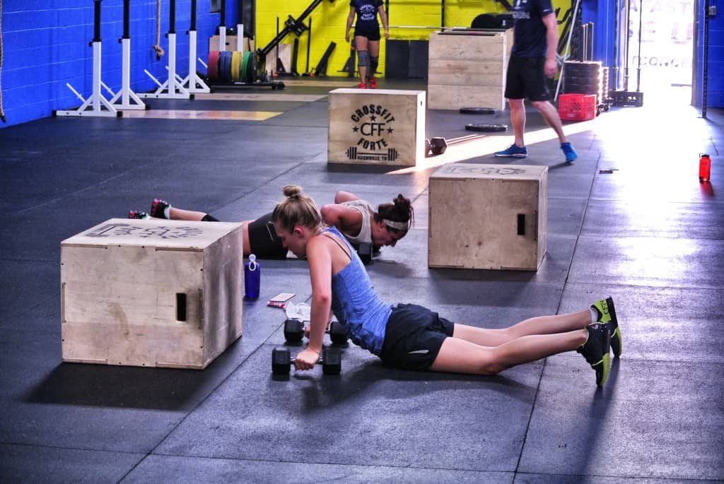 Kristen and Rae doing some dumbbell burpee box step overs
